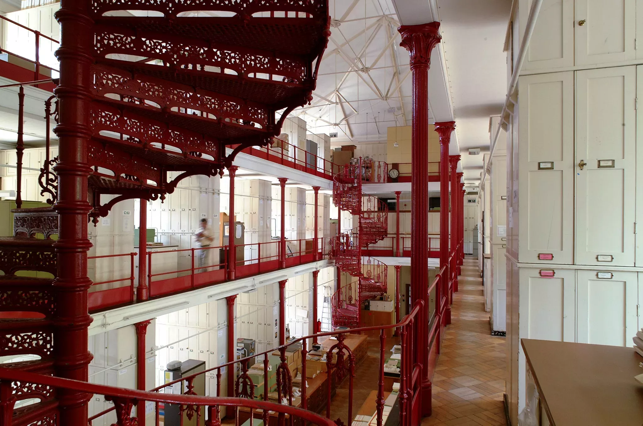 Inside wing C of Kew's Herbarium showing the red spiraling staircase from a Victorian era.