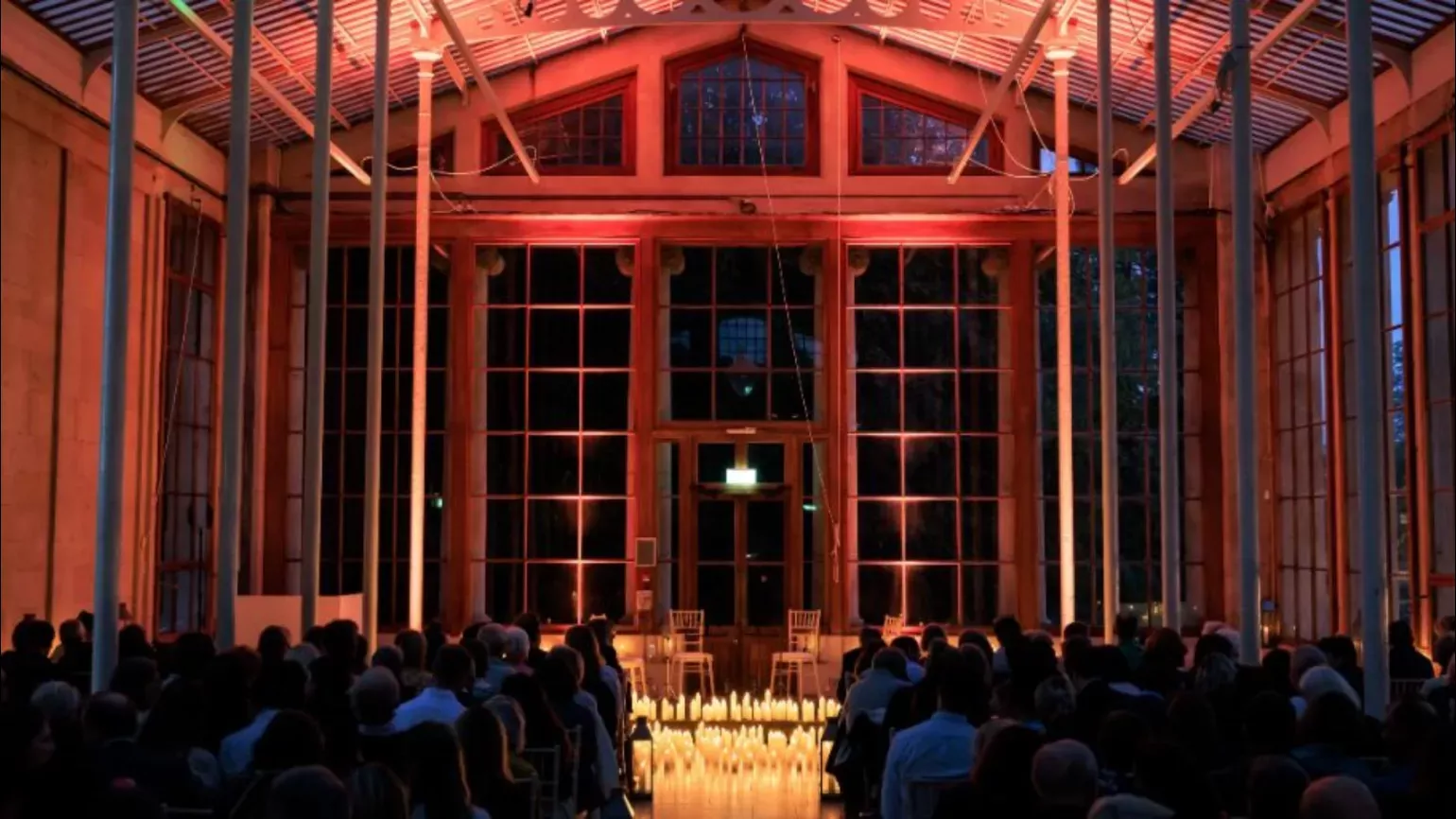 A candlelit interior of a grand conservatory