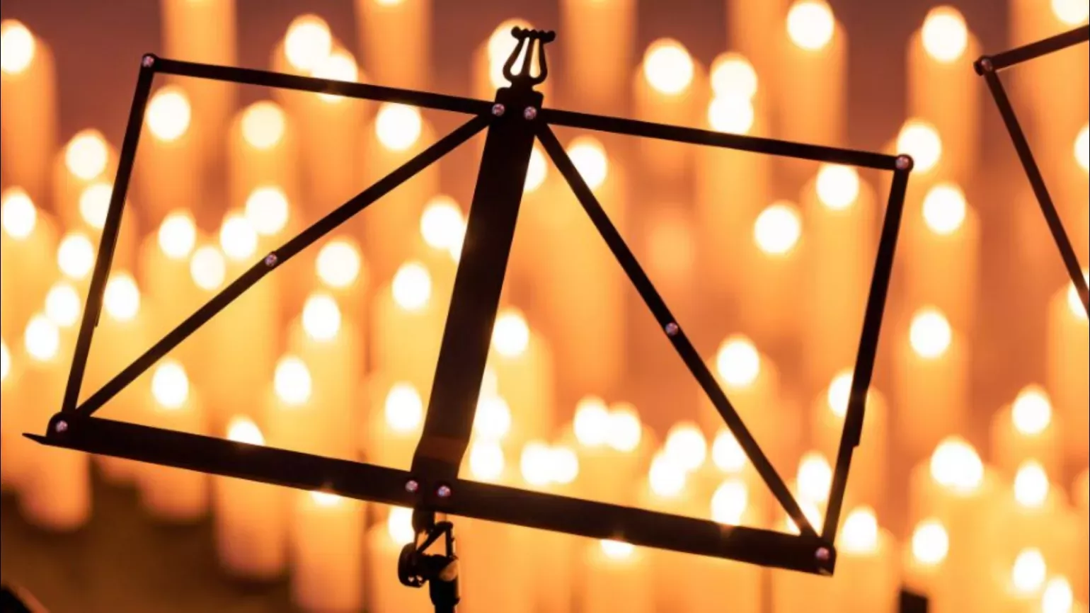 A music stand in front of candles