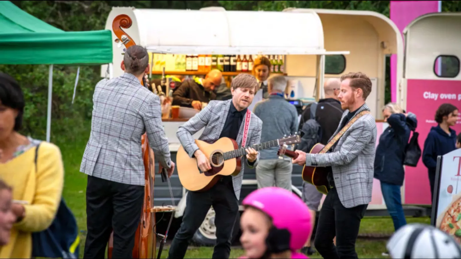 A band playing in a food truck area