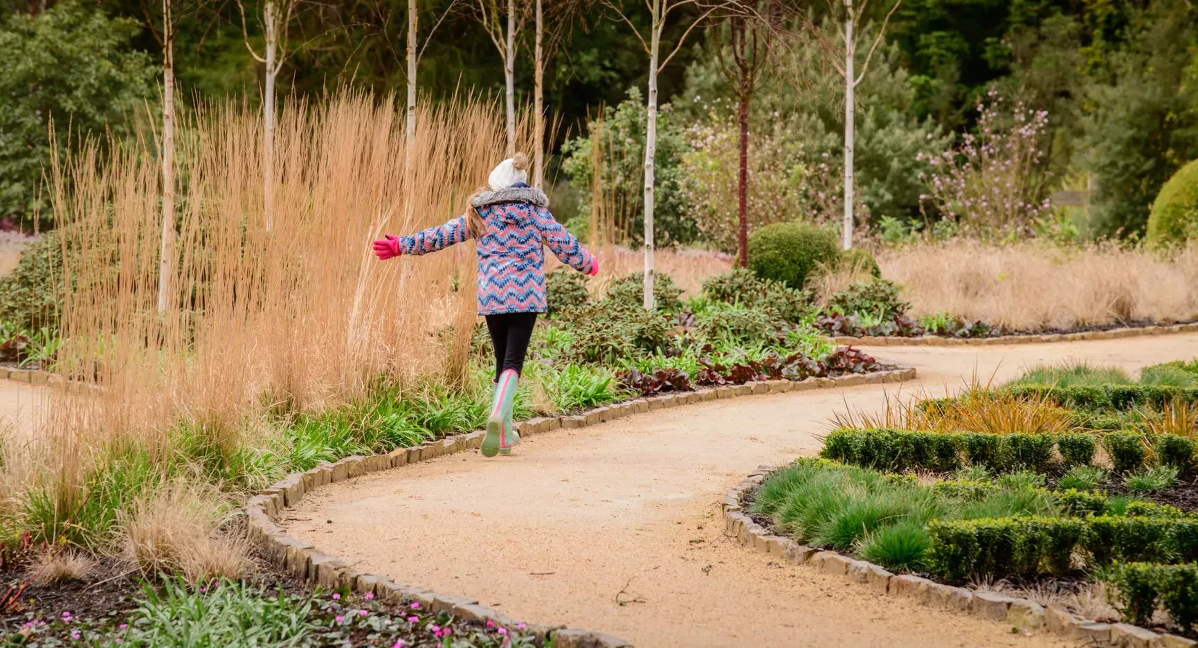 Young girl amongst grass in Winter Garden